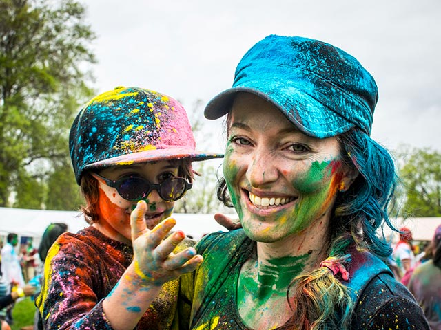 Girl holding child with colors